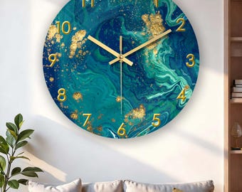 Puede incluir: Reloj de pared redondo con un diseño veteado en color turquesa y dorado. La esfera del reloj presenta números y manecillas doradas. El reloj está montado en una pared blanca sobre un sofá.