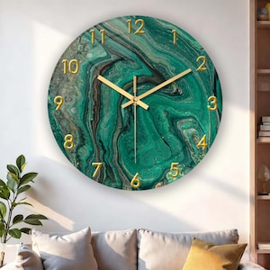 May include: Circular wall clock featuring a green marble effect face with gold numerals and hands. The clock is mounted on a white wall. The clock face has a swirling pattern of green, black, and gold. The clock is a decorative item.
