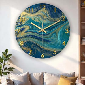 May include: Round wall clock with a blue and gold marbled design. The clock face features gold numerals and hands, creating a luxurious aesthetic. The clock is a decorative item for home decor.