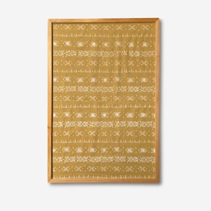 Op de afbeelding: Een ingelijste print met een mosterdgele achtergrond en een herhalend wit geometrisch patroon. Het patroon bestaat uit horizontale lijnen met verschillende vormen en stippen. De houten lijst geeft het kunstwerk een natuurlijke uitstraling.