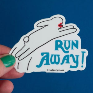 May include: A white sticker featuring a cartoon rabbit in mid-leap, with the words "RUN AWAY!" in teal. The artist's name is at the bottom. The sticker is set against a blue backdrop.