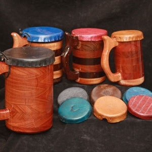 May include: Four wooden mugs with different colored lids and a variety of wooden coasters in blue, brown, and red.