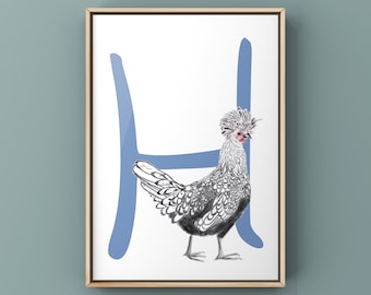 Op de afbeelding: Een ingelijst afdruk van een zilveren en zwarte kip die voor een blauwe letter H staat. De kip heeft een grote, pluizige kam.