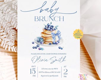 May include: A baby brunch invitation with a watercolor illustration of pancakes topped with blueberries and a blue bow. The invitation includes the text "baby brunch" and details for a baby shower honoring Olivia Smith.