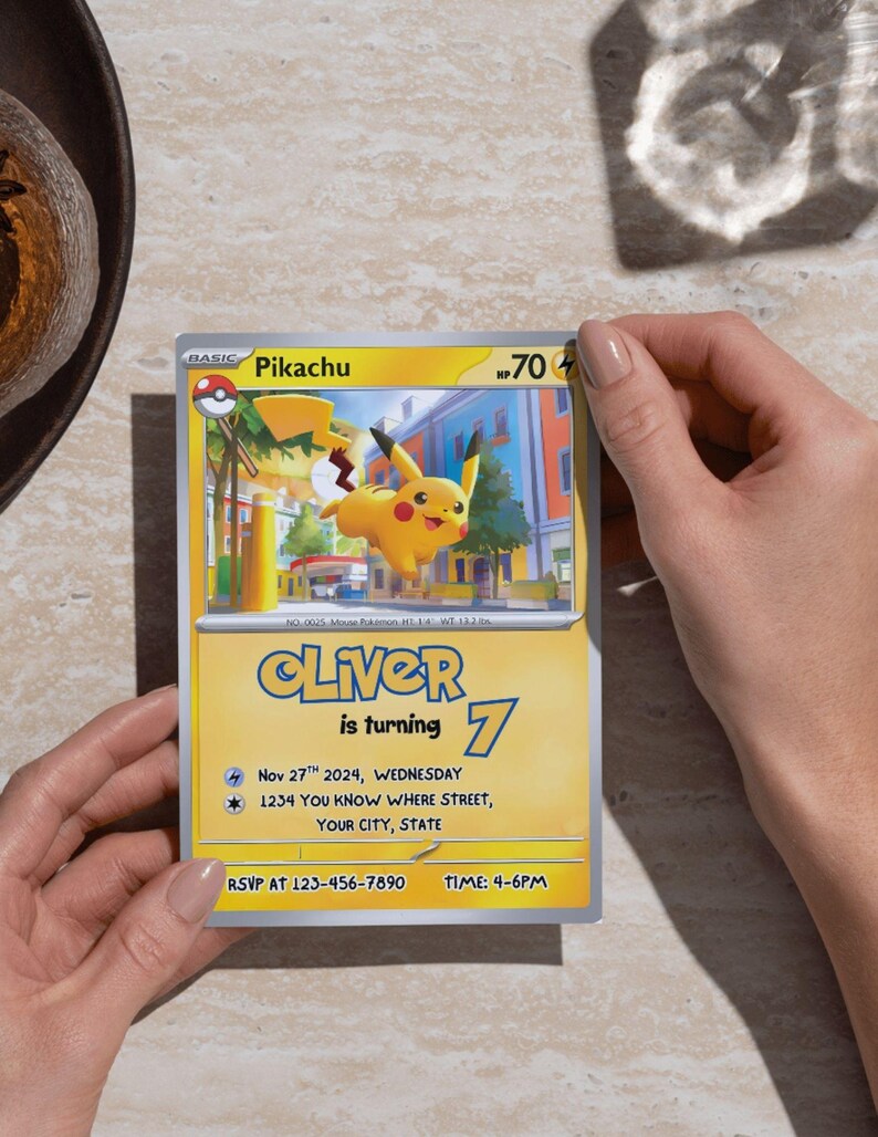 May include: A Pikachu-themed birthday invitation featuring a yellow and blue design. The invitation includes the name "Oliver", the number "7", and event details. The card is held by a person.