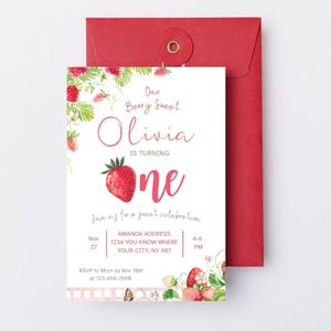May include: A white invitation card with a red envelope. The invitation features the text "Our Berry Sweet Olivia is turning one" with a large strawberry illustration. Additional text includes party details and RSVP information.