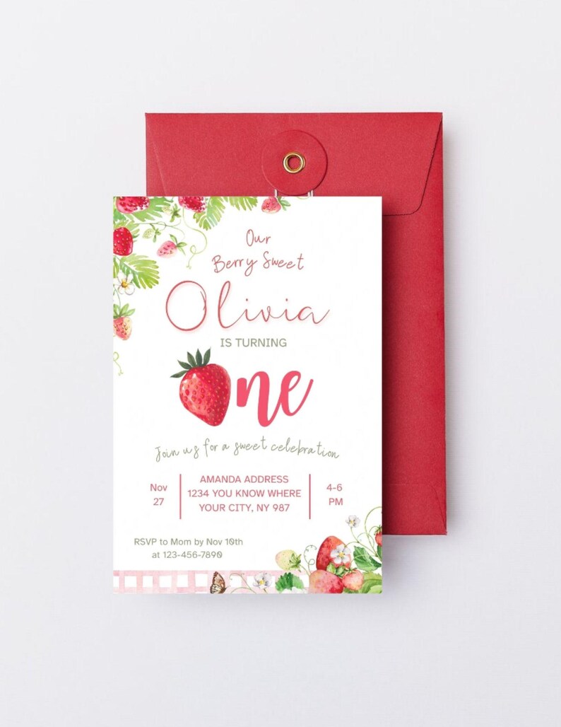 May include: A white invitation card with a red envelope. The invitation features the text "Our Berry Sweet Olivia is turning one" with a large strawberry illustration. Additional text includes party details and RSVP information.