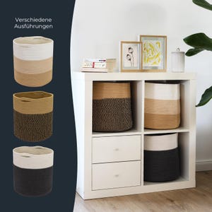 Op de afbeelding: Een collectie cilindervormige opbergmanden van gevlochten touw, met tweekleurige combinaties zoals wit en beige, beige en zwart, of wit en zwart. De manden zijn voorzien van geïntegreerde handgrepen en worden in verschillende opstellingen getoond.