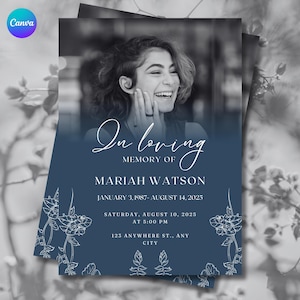 May include: A navy blue memorial card with a black and white photo of a smiling woman. The text reads "In loving memory of Mariah Watson" with dates and event details. Floral line art decorates the edges.