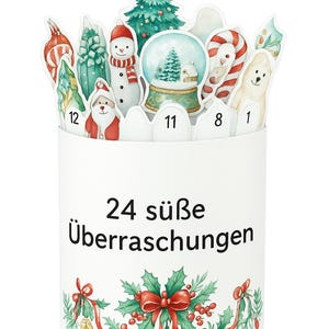 May include: A white cylindrical advent calendar with festive cutouts of a snowman, Santa, a Christmas tree, and a snow globe. The calendar has the text "24 s&uuml;&szlig;e &Uuml;berraschungen" and is decorated with holly and a red bow.