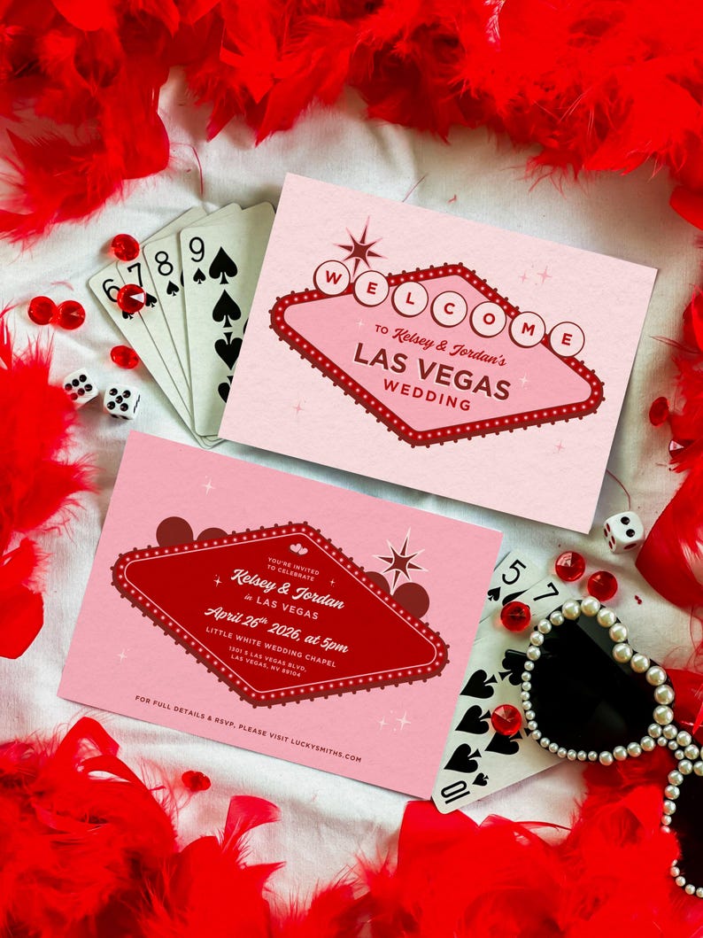 May include: Two pink Las Vegas wedding invitations with red text and a retro design, surrounded by playing cards, dice, and red feather boa. One invitation reads "Welcome to Kelsey & Jordan's Las Vegas Wedding."