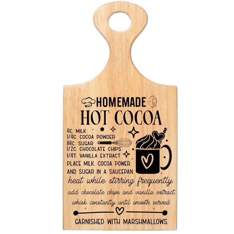 May include: Wooden cutting board with a handle, featuring a recipe for homemade hot cocoa. The recipe includes ingredients like milk, cocoa powder, sugar, chocolate chips, and vanilla extract. The board is decorated with illustrations and text.