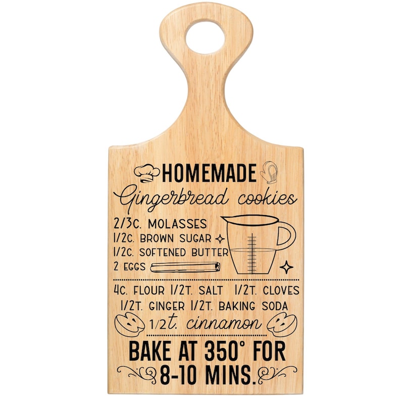 May include: A light-colored wooden cutting board with a handle, featuring a recipe for homemade gingerbread cookies. The recipe includes ingredients like molasses, brown sugar, and flour, with instructions to bake at 350 degrees Fahrenheit for 8-10 minutes.
