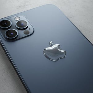 May include: A dark blue smartphone featuring a triple-lens camera and a silver Apple logo. The phone's glossy surface reflects light, highlighting its sleek design. The camera lenses are black and circular.