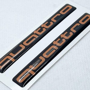 Audi quattro 3D Domed Gel Stickers (2-Pack): Black & Orange Automotive Decals