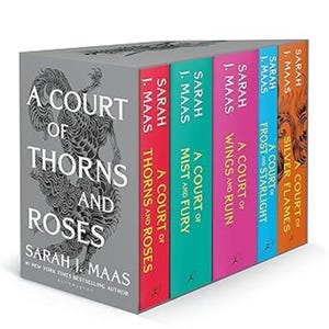 May include: A boxed set of fantasy novels by Sarah J. Maas. The set includes five books with colorful spines: red, teal, pink, blue, and orange. The first book's cover is gray with the title "A Court of Thorns and Roses."
