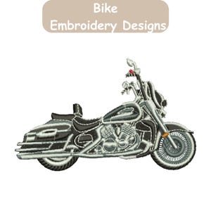 May include: An embroidery design of a motorcycle in shades of black, gray, and white, featuring detailed engine components, spoked wheels, and a seat. Above the motorcycle, a tan rectangular label displays the text Bike Embroidery Designs.