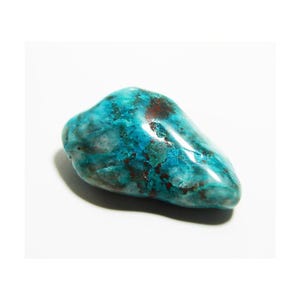 May include: A polished, irregularly shaped stone with a vibrant turquoise hue, accented by patches of deep red and brown. The gemstone has a smooth, glossy surface, and is set against a white background.