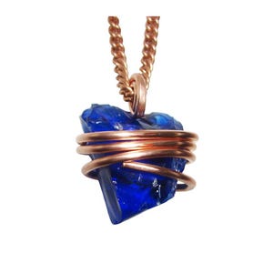 May include: A blue crystal pendant necklace. The raw, faceted blue crystal is wrapped in copper wire and suspended from a copper chain. The pendant is centered against a white background.