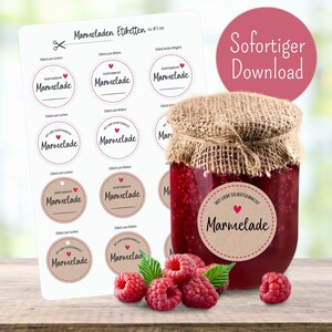May include: A jar of homemade marmalade with a burlap lid, surrounded by fresh raspberries and a sheet of round labels. The labels read "Marmelade" and "Homemade with Love."