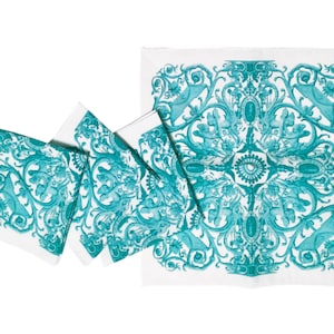 May include: Set of four teal blue and white patterned linen napkins. The napkins feature a repeating design of stylized floral and animal motifs.