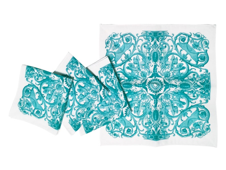 May include: Set of four teal blue and white patterned linen napkins. The napkins feature a repeating design of stylized floral and animal motifs.