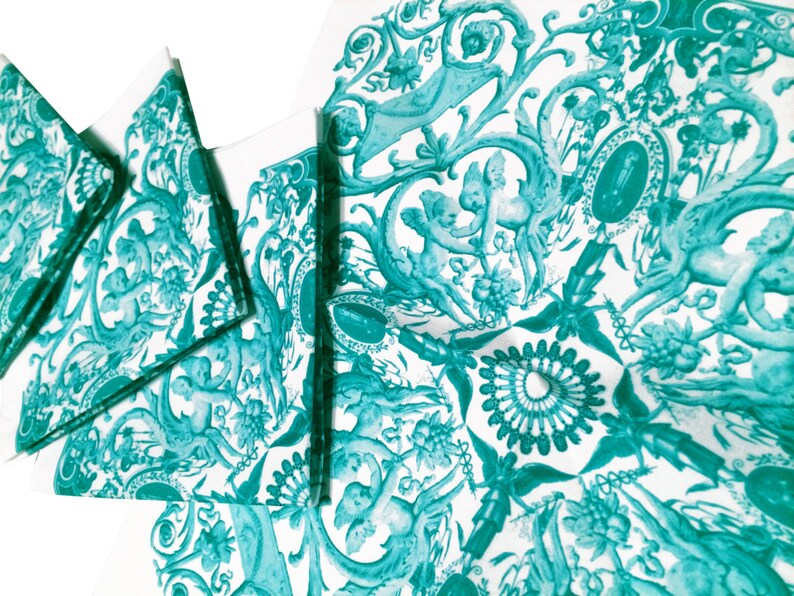May include: A set of teal blue napkins with a repeating pattern of cherubs, flowers, and vines on a white background.