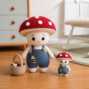 May include: Two crochet mushroom figures, one large and one small, with red and white caps and blue overalls. The larger mushroom holds a small woven basket with flowers. The figures have smiling faces and are set on a wooden floor.