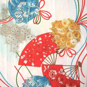 May include: A white fabric featuring a pattern of red folding fans, yellow chrysanthemum clusters, and blue floral spheres. The design includes thin red, blue, and green ribbons, along with a gold-toned geometric honeycomb pattern overlay.