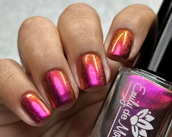 Nail polish - "Vague Memories" A large particle multichrome that shifts from a dark burgundy pink / orange / gold.