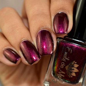 Nail polish - "Shades Of Night" A dark purple base with pink / orange / green shifting aurora shimmer.