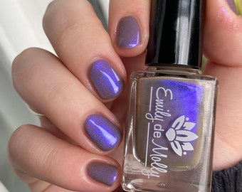 Nail polish - "Written Invitation" A taupe brown base with a blue / purple shifting aurora shimmer.