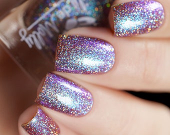 Nail polish - Never Stood A Chance - A pale brown nail polish with a vibrant green / blue / purple shimmer and holo glitters.