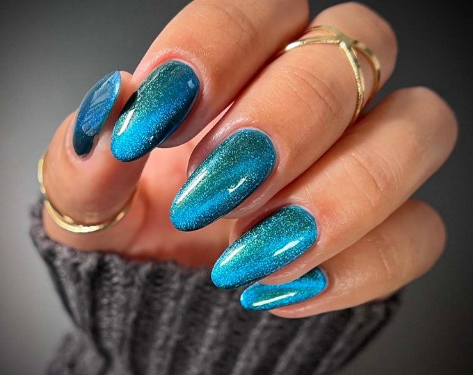 Nail polish - "Until The Last" A dark green magnetic with a vibrant blue catseye effect.