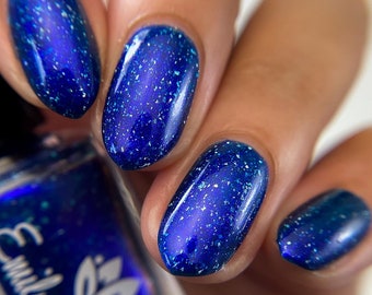 Nail polish - "All You Wanted To Be" A dark navy polish with blue aurora shimmer and silver holographic flakes.