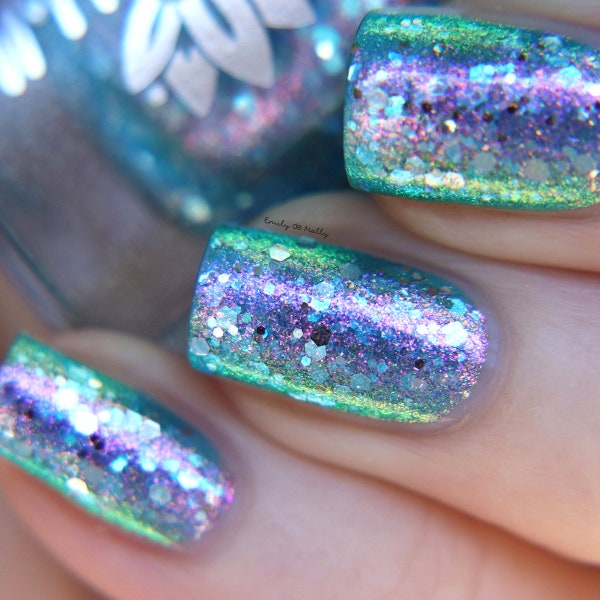 Nail polish - "Turning Tides" A pale aqua blue jelly base with pink / green / blue aurora shimmer and silver glitters