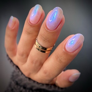 Blue Shimmer Nail Polish - Key Drama - A clear nail polish filled with an intense vivid blue aurora shimmer.