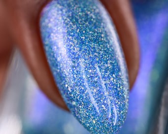 Nail Polish - On My Mind - A light blue nail polish with blue shimmer and silver holo flakes.