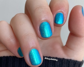 Nail polish - Idle Winds - A cyan blue nail polish with a strong green shimmer.