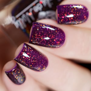 Glitter nail polish - The Least I Could Do - A dark purple nail polish filled with iridescent glitters.