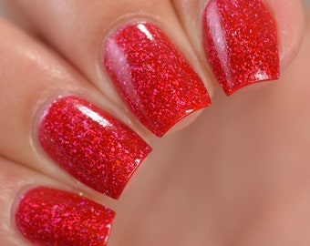 Nail polish - "Pay The Price"  A bright red with silver holographic flakes.