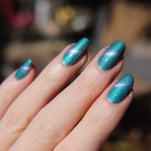 Nail polish - "Synthetic Dreams" A turquoise green base with a light purple / pink / gold shifting magnetic effect.