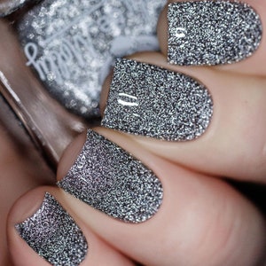 Nail polish - "To Dust A grey base with silver reflective micro glitters.