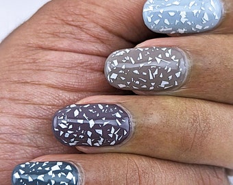 Nail polish - Isolate - A glitter topper with white shredded glitters.