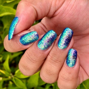 Flakie nail polish - Begin At The End -  An ultramarine blue nail polish with orange / gold / green / blue shifting iridescent flakes.