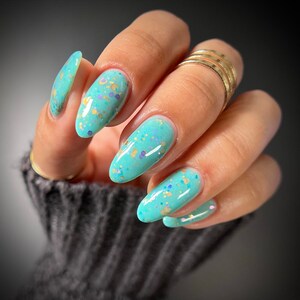 Glitter nail polish - Serenity - A green leaning blue crelly nail polish with copper, lavender and turquoise glitters.