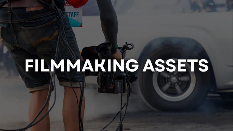 May include: A person holding a professional video camera, with the text "FILMMAKING ASSETS" in white. A white car is in the background, with smoke rising from the tires. The scene suggests a film production or automotive event.