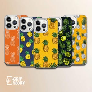 May include: Five phone cases with pineapple patterns. The cases have orange, navy blue, yellow, black, and yellow backgrounds. The pineapple illustrations are in white, yellow, and green. The brand name "GRIPHEORY" is visible at the bottom.