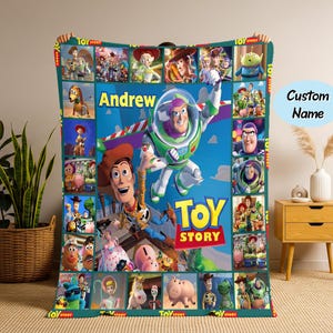 May include: A vibrant Toy Story blanket featuring Buzz Lightyear and Woody. The blanket has a blue background with character images and the text "Andrew" and "Toy Story".
