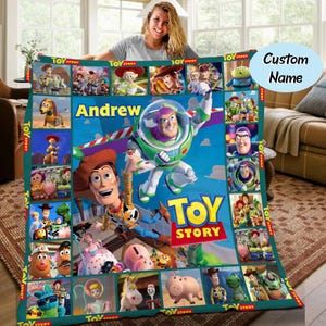 May include: A personalised blanket with characters from the animated film "Toy Story." The blanket has a blue background with images of Buzz Lightyear, Woody, and other characters. The name "Andrew" is displayed in large, yellow letters.